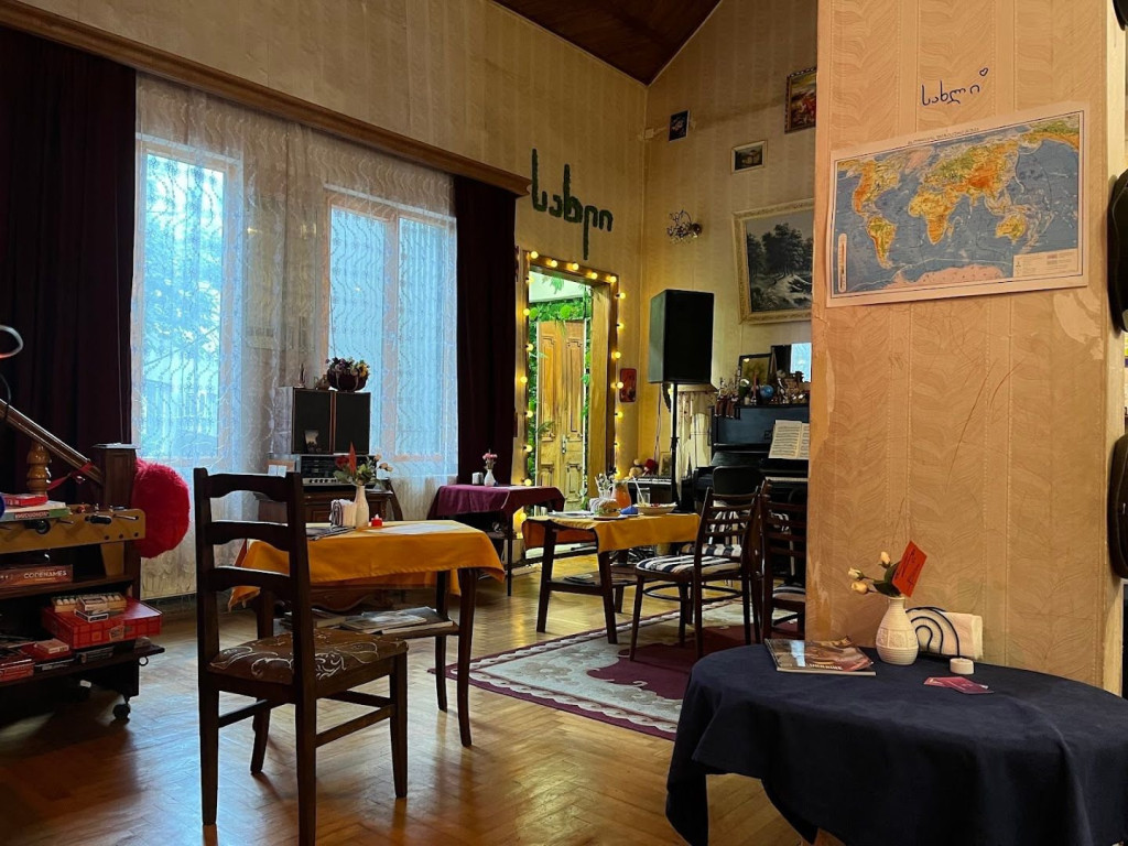 Sakhli’s dining room with wooden furniture and artwork